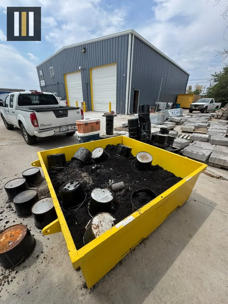 Reborn Rental yellow concrete washout pan staged on a commercial jobsite outside a Denver building.
